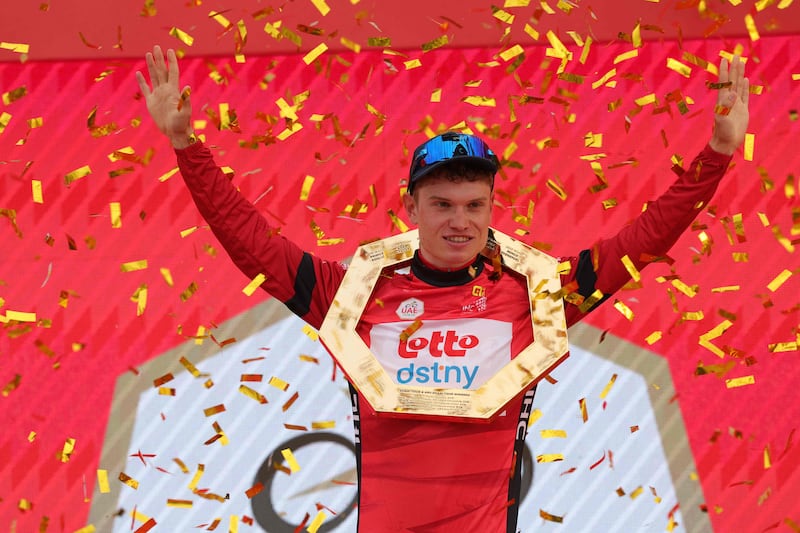 Lotto-DSTNY's Belgian cyclist Lennert Van Eetvelt celebrates after winning the general classification in the 6th UAE Tour after his victory in Stage 7 on Jebel Hafeet on February 25, 2024. AFP
