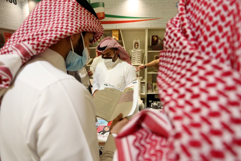 Men browse through books in Riyadh.