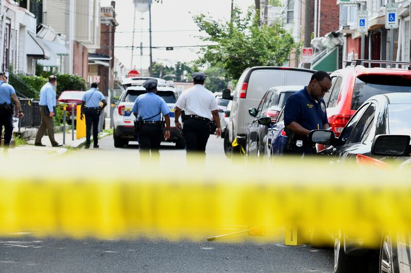 Police officers work at the scene of the shooting as investigations continue Reuters
