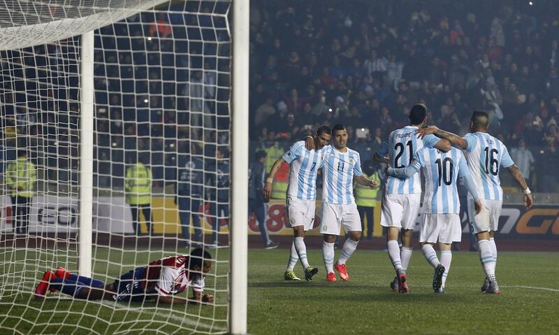 Argentina's players celebrate after Angel Di Maria, centre, scored their fourth goal in the Copa America semi-final against Paraguay. Silvia Izquierdo / AP