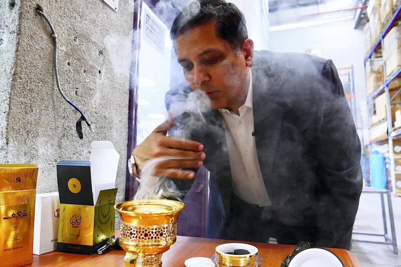 SHARJAH, UNITED ARAB EMIRATES , April 14  – 2021 :- Nader Adam Ali, Director showing the burning of bakhoor tablets  at the Swiss Arabian perfume and Bakhoor factory in Sharjah. ( Pawan Singh / The National ) For News/Online/Instagram. Story by Kelly