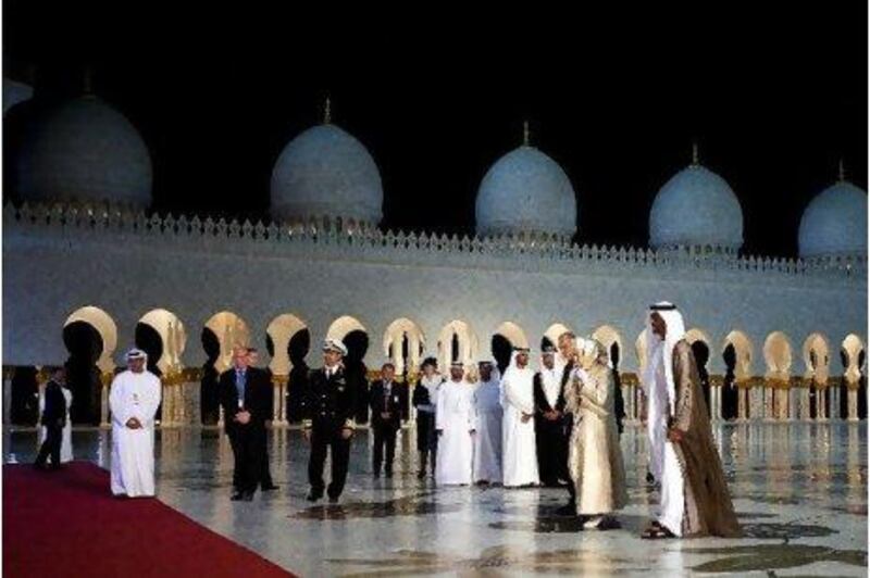 Queen Elizabeth II and her husband Prince Philip, the Duke of Edinburgh, arrive at the Sheikh Zayed Grand Mosque with Sheikh Mohammed Bin Zayed, Crown Prince and Deputy Supreme Commander of the UAE Armed Forces, and Prince Andrew, the Duke of York, yesterday.