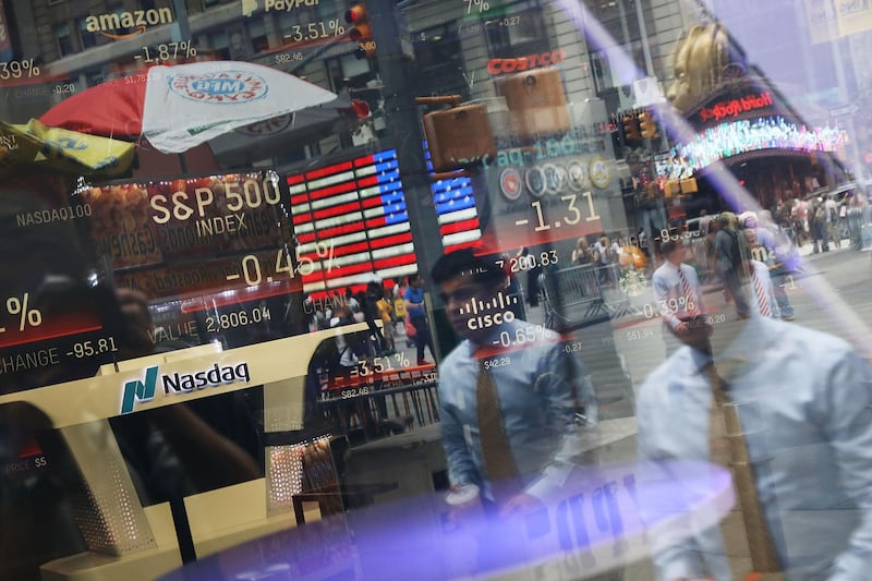 NEW YORK, NY - JULY 30: People are reflected in the window of the Nasdaq MarketSite in Times Square on July 30, 2018 in New York City. As technology stocks continued their slide on Monday, the Nasdaq Composite dropped 1.1 percent in afternoon trading with shares of Facebook, Netflix, Amazon and Google-parent Alphabet all declining.   Spencer Platt/Getty Images/AFP
== FOR NEWSPAPERS, INTERNET, TELCOS & TELEVISION USE ONLY ==
