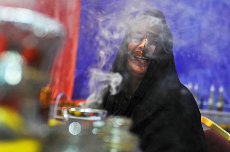 An Emirati woman selling oud waits for shoppers to arrive at the popular Ramadan and Eid Festival at Adnec, which finishes on Saturday. Delores Johnson / The National
