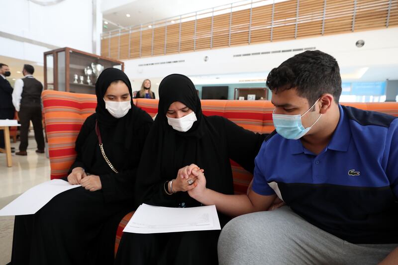 Sarah (L) and Abdulla Alshamsi receive their GCSE results with their mother. 