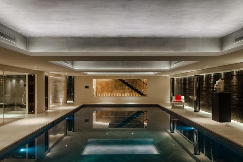 An underground indoor swimming pool boasts a floor which rises up to create a spacious level entertainment space. Courtesy Savills