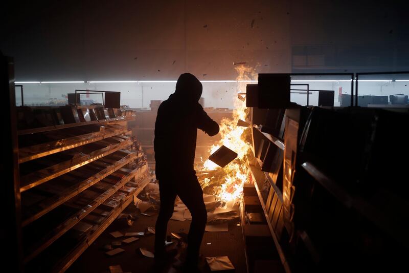 People loot then burn an Office Depot in Minneapolis on May 29, 2020. AP Photo