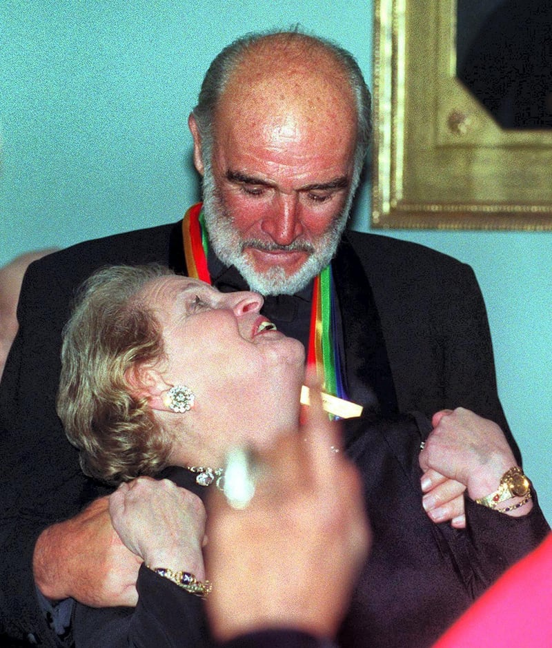 Actor Sean Connery grabs US Secretary of State Madeleine Albright at the State Department in Washington, DC late 04 December 1999 following a dinner for the Kennedy Center Honorees. The event celebrates the careers of five performing arts legends: comedian and pianist Victor Borge, actor Sean Connery, dancer and teacher Judith Jamison, actor Jason Robards and singer and songwriter Stevie Wonder. The 1999 Honorees will be saluted by their peers at a gala  at the Kennedy Center 's Opera House 05 December. AFP PHOTO Neshan H. NALTCHAYAN (Photo by NESHAN NALTCHAYAN / AFP)