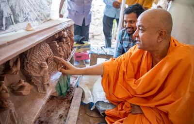 Swami Brahmavihari, head of international relations for Baps Swaminarayan Sanstha, the organisation building the temple in Abu Dhabi, checks the engravings in India. Photo: Baps Hindu Mandir 