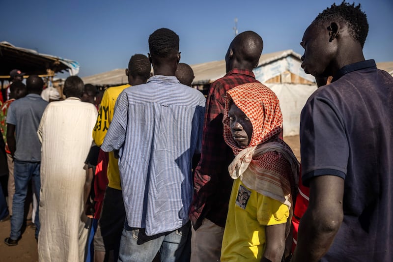 People who fled the war in Sudan wait to be registered at the Joda Border Crossing Point. More than 200 people share one toilet at the transit centre in Renk and cases of cholera and measles are on the rise