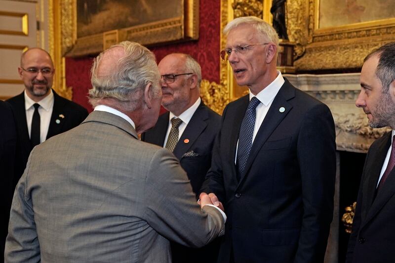 King Charles shakes hands with Latvian Prime Minister Krisjanis Karins during the reception. PA 