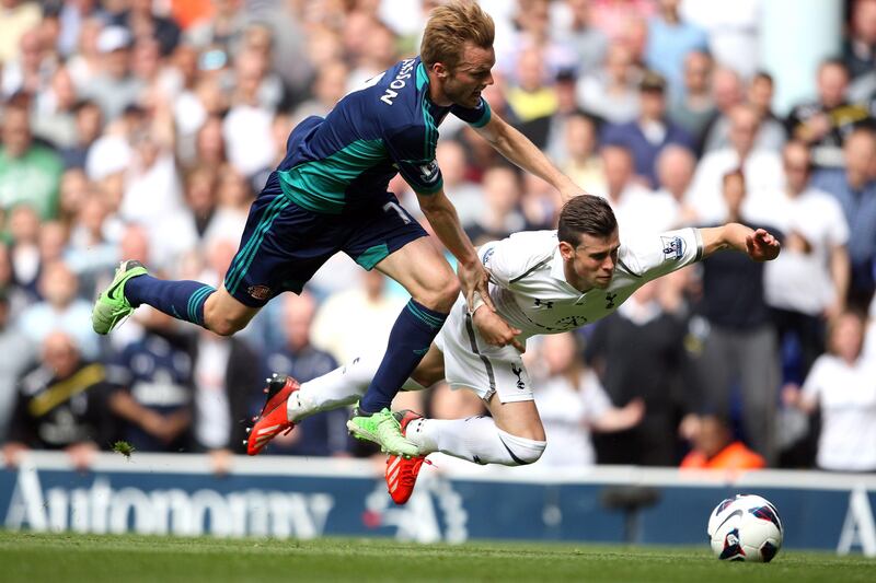 Tottenham Hotspur's Gareth Bale, right, goes down to the ground with Sunderland's Sebastian Larsson and earns a yellow card for diving during the English Premier League soccer match at White Hart Lane, London, Sunday May 19, 2013. (AP Photo/PA, Stephen Pond) UNITED KINGDOM OUT NO SALES NO ARCHIVE *** Local Caption ***  Britain Soccer Premier League.JPEG-0e1be.jpg