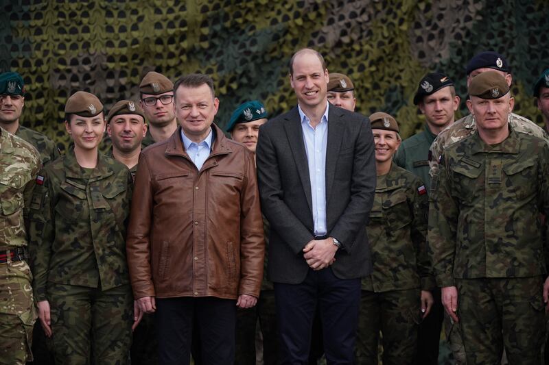 Prince William and Mr Blaszczak pose for a group photo with British and Polish troops. Getty