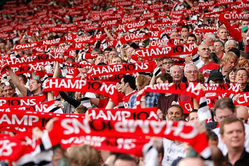 Manchester United fans display their scarves before their 3-0 win against Tottenham to commemorate their 19th league title from last season.

Tim Hales / AP Photo