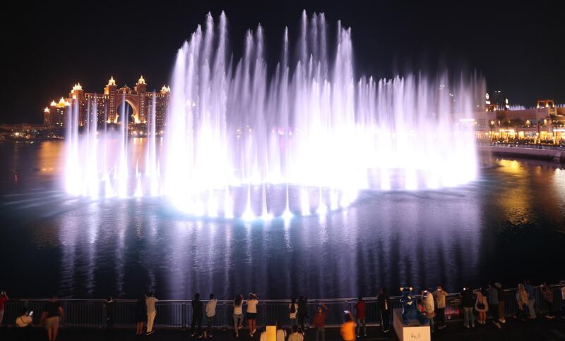 People watch the Palm fountain at the Pointe in Palm Jumeirah. EPA