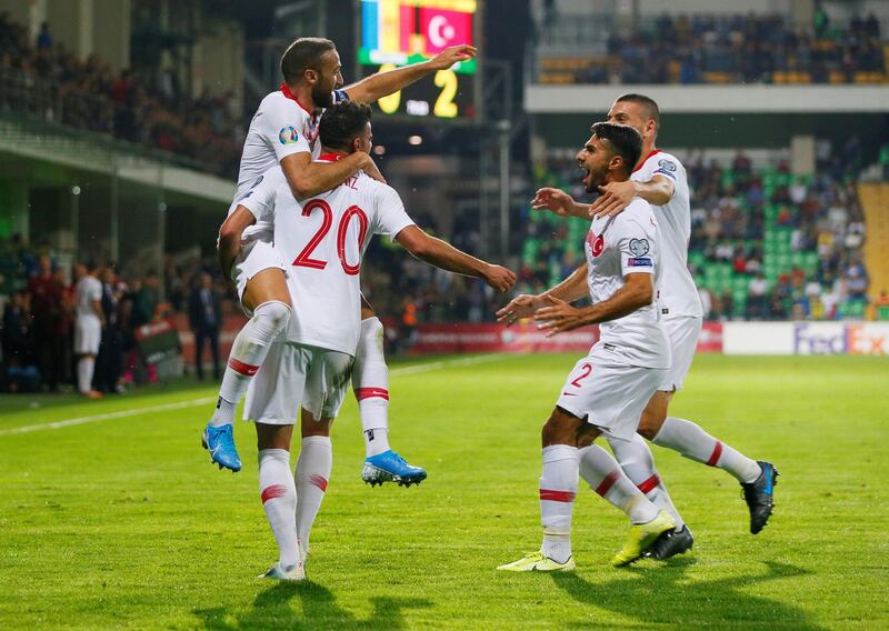 Turkey's Cenk Tosun celebrates scoring their third goal with teammates. Reuters