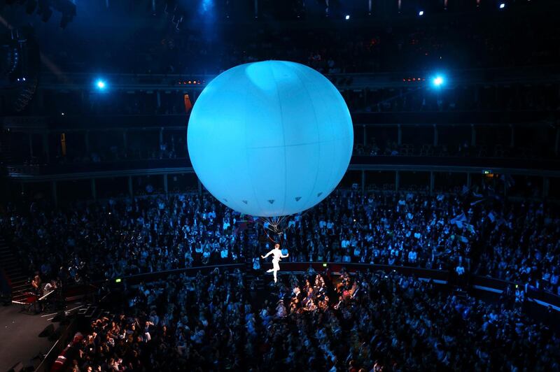 People watch the opening ceremony of the One Young World summit in which Britain's Meghan, Duchess of Sussex attended at the Royal Albert Hall, London Tuesday, Oct. 21, 2019. The One Young World Summit is a global forum for young leaders, bringing together 2,000 young people from over 190 countries around the world.  (Gareth Fuller/Pool Photo via AP)