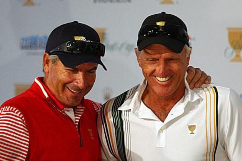 Fred Couples, the US captain, left, and Greg Norman, the International captain, discuss the first day's fourball pairings after the draw saw Tiger Woods playing against Adam Scott tomorrow.
