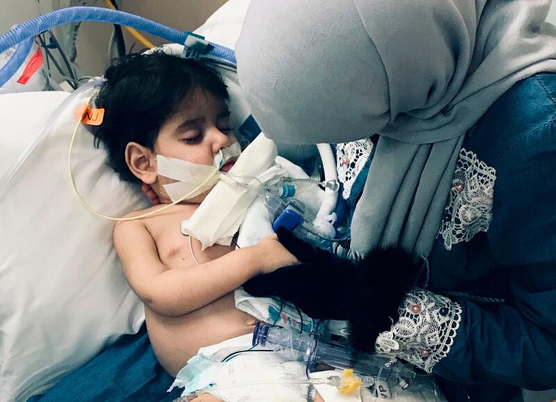 In this December 2018 photo released by the Council on American Islamic Relations, Sacramento Valley, Shaima Swileh, of Yemen, holds her dying 2-year old son Abdullah Hassan at UCSF Benioff Children's Hospital in Oakland, Calif. USA. The Council on American-Islamic Relations announced Friday, Dec. 28, 2018, that Abdullah died at the Oakland hospital, where his father Ali Hassan brought him in the fall to get treatment for a genetic brain disorder. Swileh, who is not an American citizen, sued the Trump administration to let her into the country to be with the ailing boy. (Council on American Islamic Relations, Sacramento Valley via AP)