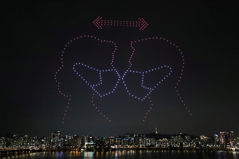 Drones fly over the Han river showing messages to support the country, as measures to avoid the spread of the coronavirus disease (COVID-19) continue, in Seoul, South Korea, July 4, 2020. Picture taken July 4, 2020. Yonhap via REUTERS ATTENTION EDITORS - THIS IMAGE HAS BEEN SUPPLIED BY A THIRD PARTY. SOUTH KOREA OUT. NO RESALES. NO ARCHIVE. TPX IMAGES OF THE DAY