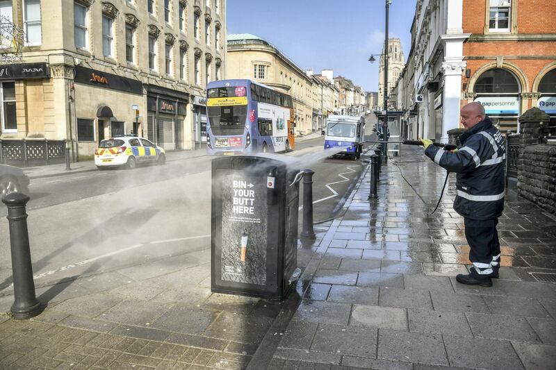 Workers from the Bristol City Centre Business Improvement District (BID) cleaning high contact public areas around Park Street and College Green, Bristol, using hot water with disinfectant and a high pressure hose, as the UK continues in lockdown to help curb the spread of the coronavirus. The cleaning opertaion is concentrating on surfaces that have a high level of public contact. (Photo by Ben Birchall/PA Images via Getty Images)