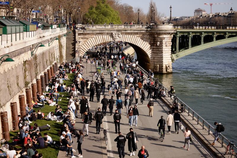 People take a walk along the Quay of the Seine river in Paris, France. EPA