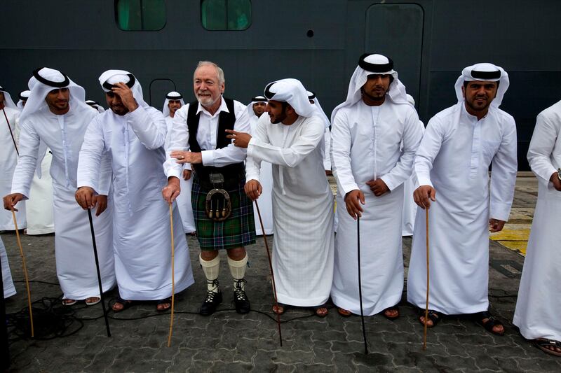 Abu Dhabi, United Arab Emirates, January 29, 2013:    A passenger dances with Emirati performers after disembarking from the Queen Mary 2 ocean liner docks for the first time at Mina Zayed in Abu Dhabi on January 29, 2013. Christopher Pike / The National