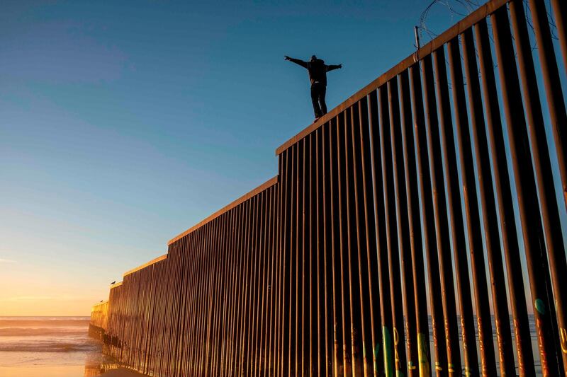 Honduran migrant Jonatan Matamoros Flores, 33, who is traveling with the Central American migrant caravan, climbs the US-Mexico border fence for fun in Tijuana, Baja California state, Mexico. AFP