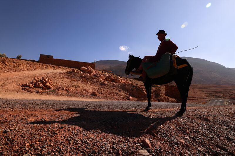 A man sits on his donkey waiting for donations in Ighil Ntalghoumt after the quake. Reuters