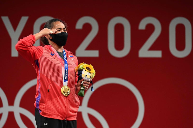 Gold medalist Hidilyn Diaz stands on the podium for the victory ceremony.