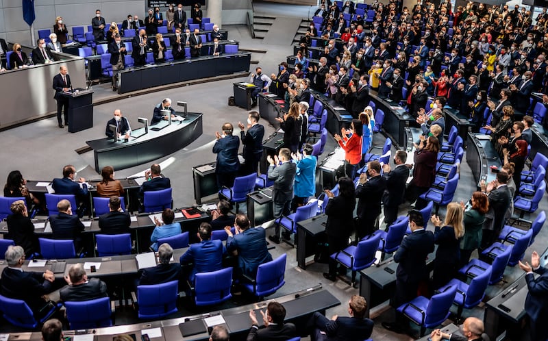 Mr Scholz receives a standing ovation after a speech on Russia's invasion of Ukraine during a meeting of the German federal parliament in February. Getty Images