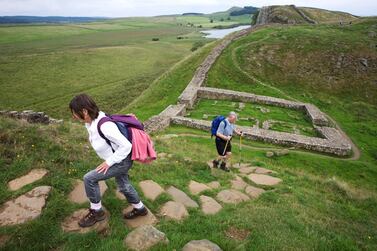 Walkers pass near the ruins of Milecastle 39 on Hadrian's Wall, once the northern frontier of Rome's empire from Barbarian tribes. In Pictures Ltd./Corbis via Getty Images