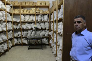 A Jordanian police officer stands by seized drugs at an anti-narcotics department in Amman April 2, 2013. Picture taken April 2, 2013.  REUTERS/Muhammad Hamed (JORDAN - Tags: DRUGS SOCIETY CRIME LAW)