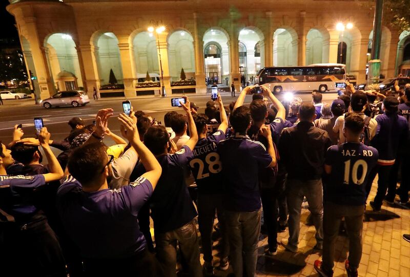 Chelsea fans cheer and take pictures as the team bus drives past after arriving in Baku for the Europa League final. Reuters