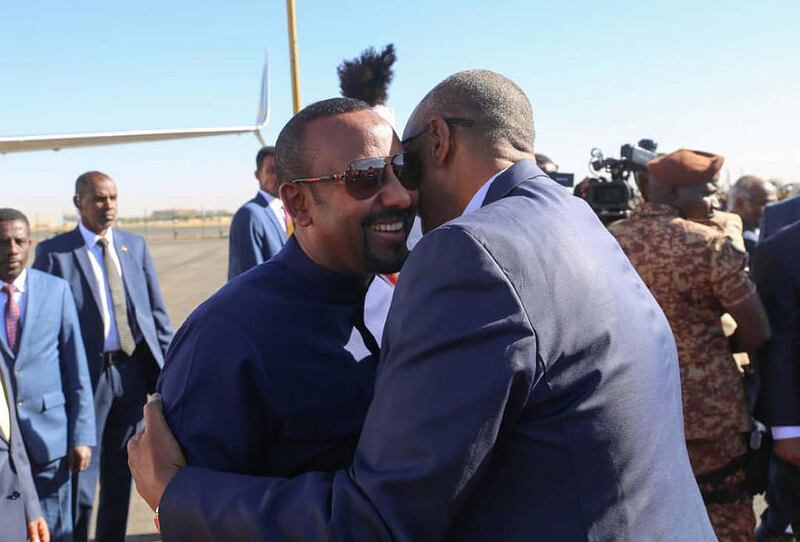Ethiopian Prime Minister Abiy Ahmed is greeted by Sudan's military leader Gen Abdel Fattah Al Burhan in Sudan. Photo: Suna Agency / Twitter