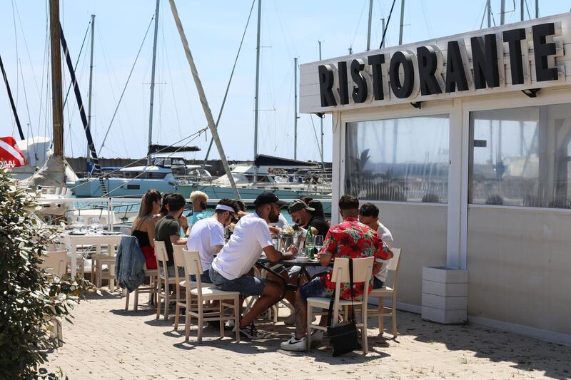 Residents have their lunch at the tourist harbor on the first weekend after the lockdown ended. Getty