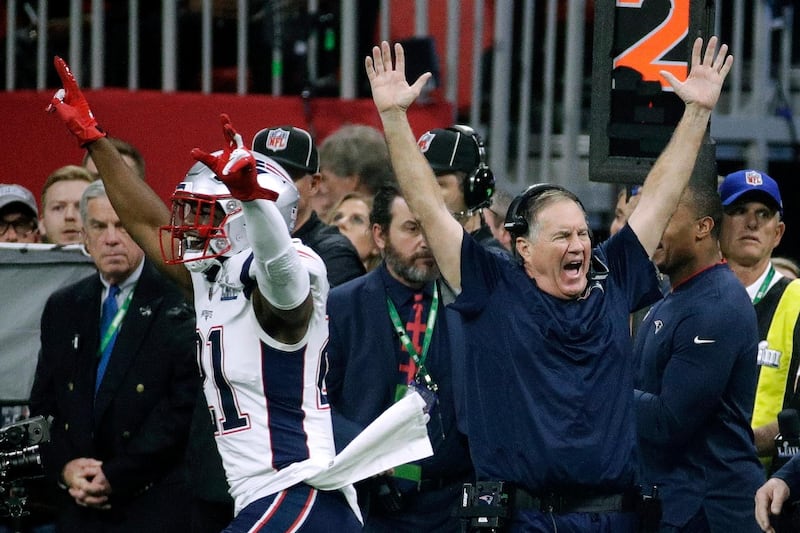 New England Patriots' head coach Bill Belichick, right, celebrates his side's historic triumph. AP Photo