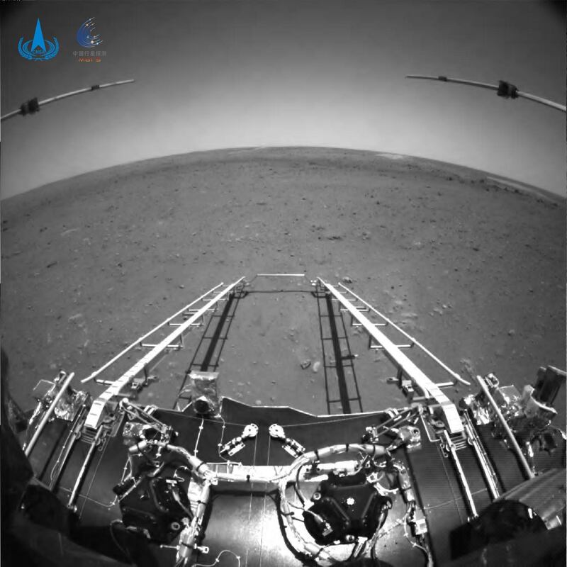 An image taken by an obstacle avoidance camera installed in front of China's Zhurong rover on the surface of Mars, showing a ramp on the lander that has been extended to the surface of the planet. EPA