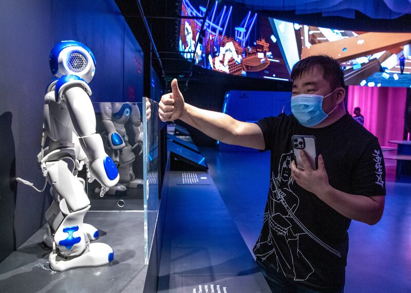 People interact with a robot at the Finland Pavilion.