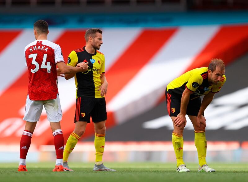 Watford's Craig Dawson, right, and Tom Cleverley, centre, after the club's relegation. EPA