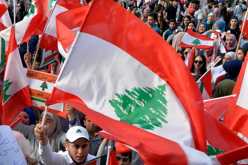 epa07984991 Lebanese students from various schools wave national flags and shout slogans during ongoing anti-government protests at al-Nour Square in Tripoli, north of Lebanon, 09 November 2019. Protesters demand the president make parliamentary consultations immediately to facilitate the formation of a new government that replaces the recently resigned Cabinet. They also demand the formation of a technocratic government with no political affiliation. Saad Hariri resigned as Prime Minister on 29 October, bringing down the entire Cabinet.  EPA/WAEL HAMZEH