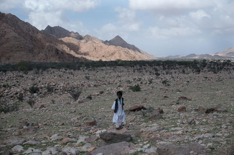 A young boy stands by a landscape view of the mountains. A photo essay profiling the Gabal Elba Protected Area (GEPA) in Egypt's Red Sea governorate, along the borders with Sudan Photo by Jihad Abaza