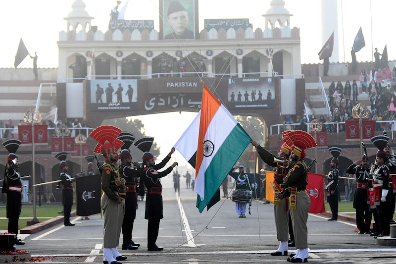Indian Border Security Force personnel (dressed in brown) and Pakistani Rangers (dressed in black) take part in the Beating Retreat ceremony at the India-Pakistan Wagah border post on January 26, 2022. Narinder Nanu / AFP