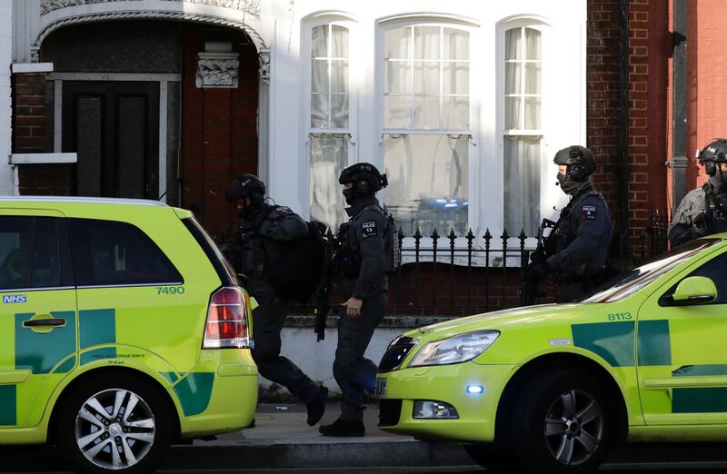 Armed policemen out on a street in west London. Kevin Coombs / Reuters
