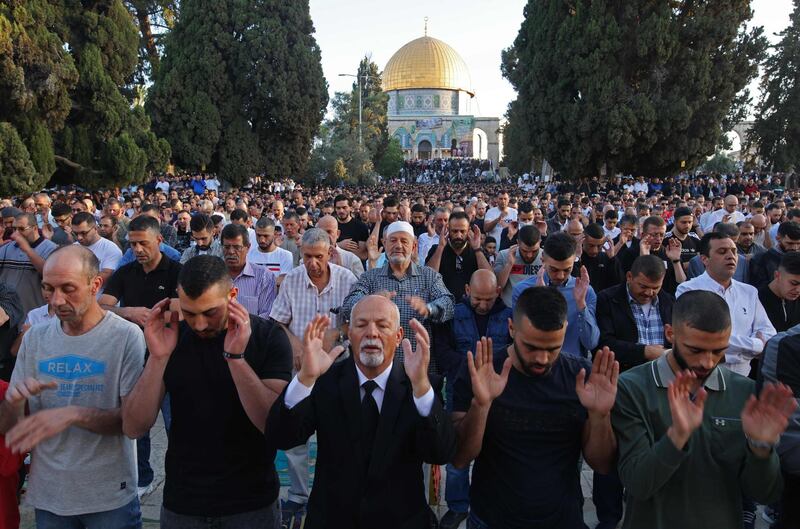 Muslims perform the morning Eid Al Fitr prayer outside the Dome of the Rock mosque in the Al Aqsa mosques compound in Old Jerusalem. Several nights of clashes between Palestinian protesters and Israeli police, particularly around Al Aqsa mosque, spiralled this week into a barrage of rocket fire from Gaza and deadly Israeli air strikes in retaliation. AFP