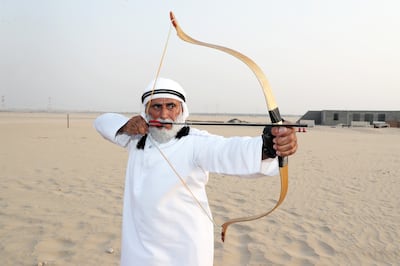 Saeed Al Dharif first teaches his students how to shoot a bow and arrow from the ground. Pawan Singh / The National
