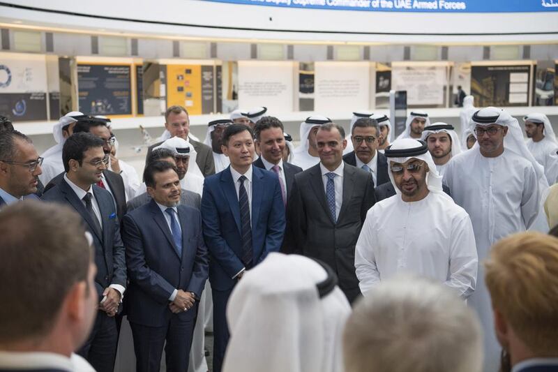 The delegation speaks with staff while visiting Al Maryah Island.  Hamad Al Kaabi / Crown Prince Court - Abu Dhabi