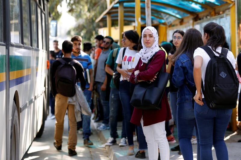 Youths wait for the bus outside Manar university in Tunis, Tunisia. Reuters