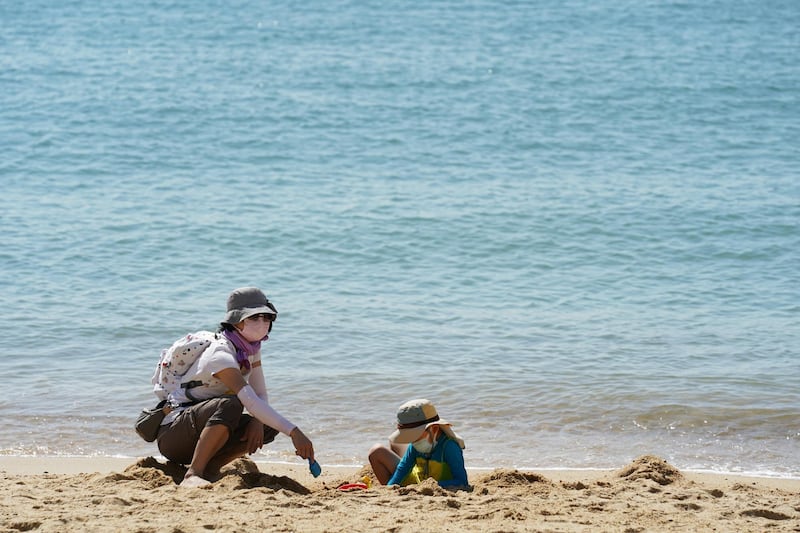 People enjoy the hot weather on a beach in Hong Kong, China. Reuters