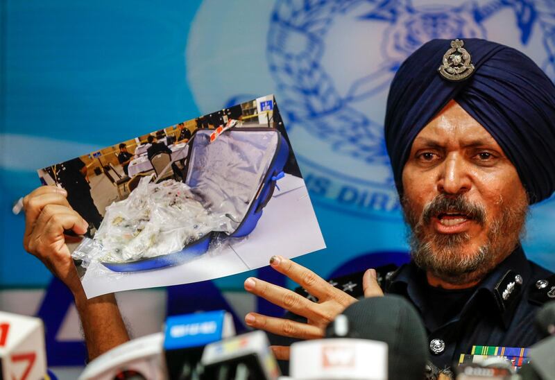 epa06843211 Malaysian Police's Commercial Crime Investigation Department (CCID) Director, Amar Singh shows a photograph of seized items from a raid at the residence of former Malaysian prime minister Najib Razak during a press conference in Kuala Lumpur, Malaysia, 27 June 2018.  EPA/AHMAD YUSNI